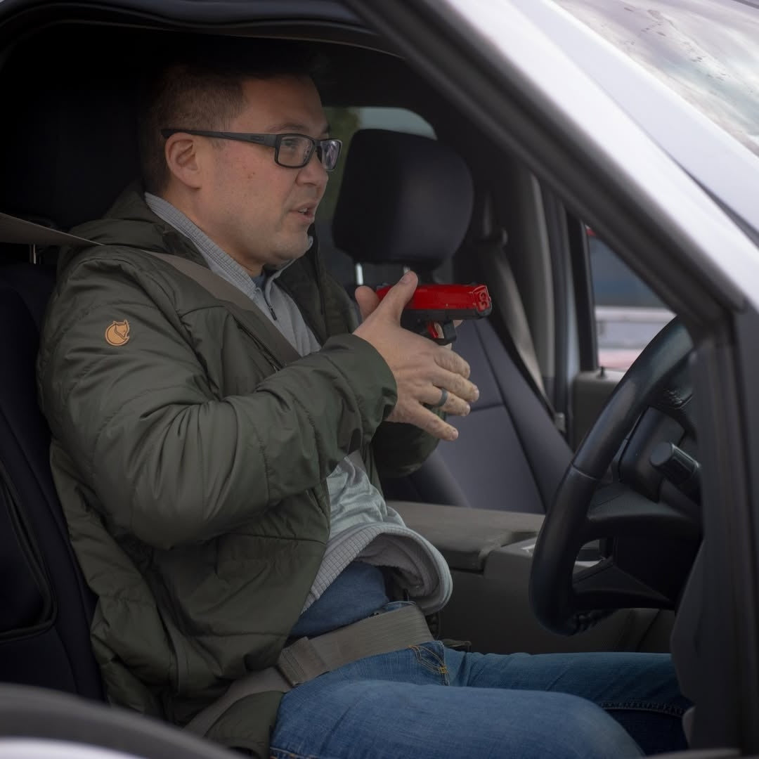 Man demonstrating self defence situation and attempting to draw a weapon to protect himself.