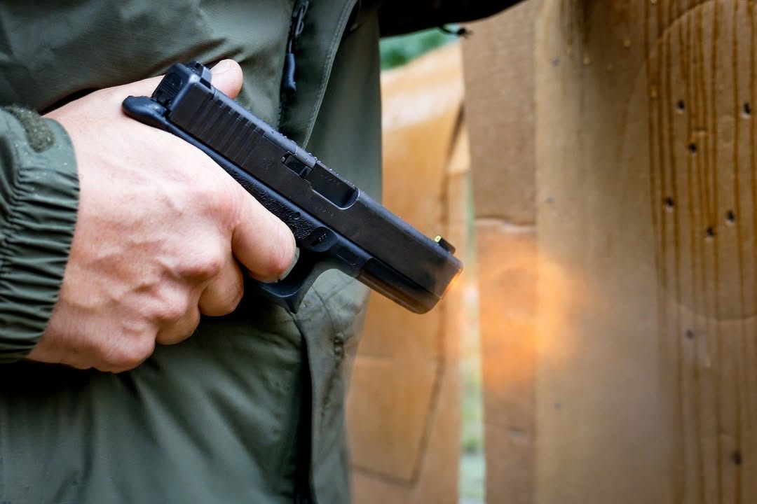 Man demonstrating muzzle flash on a handgun during a self defence shooting class.