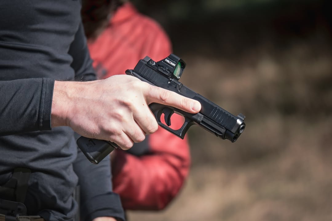 Man demonstrating safe handling of a handgun during a self defence handgun class.