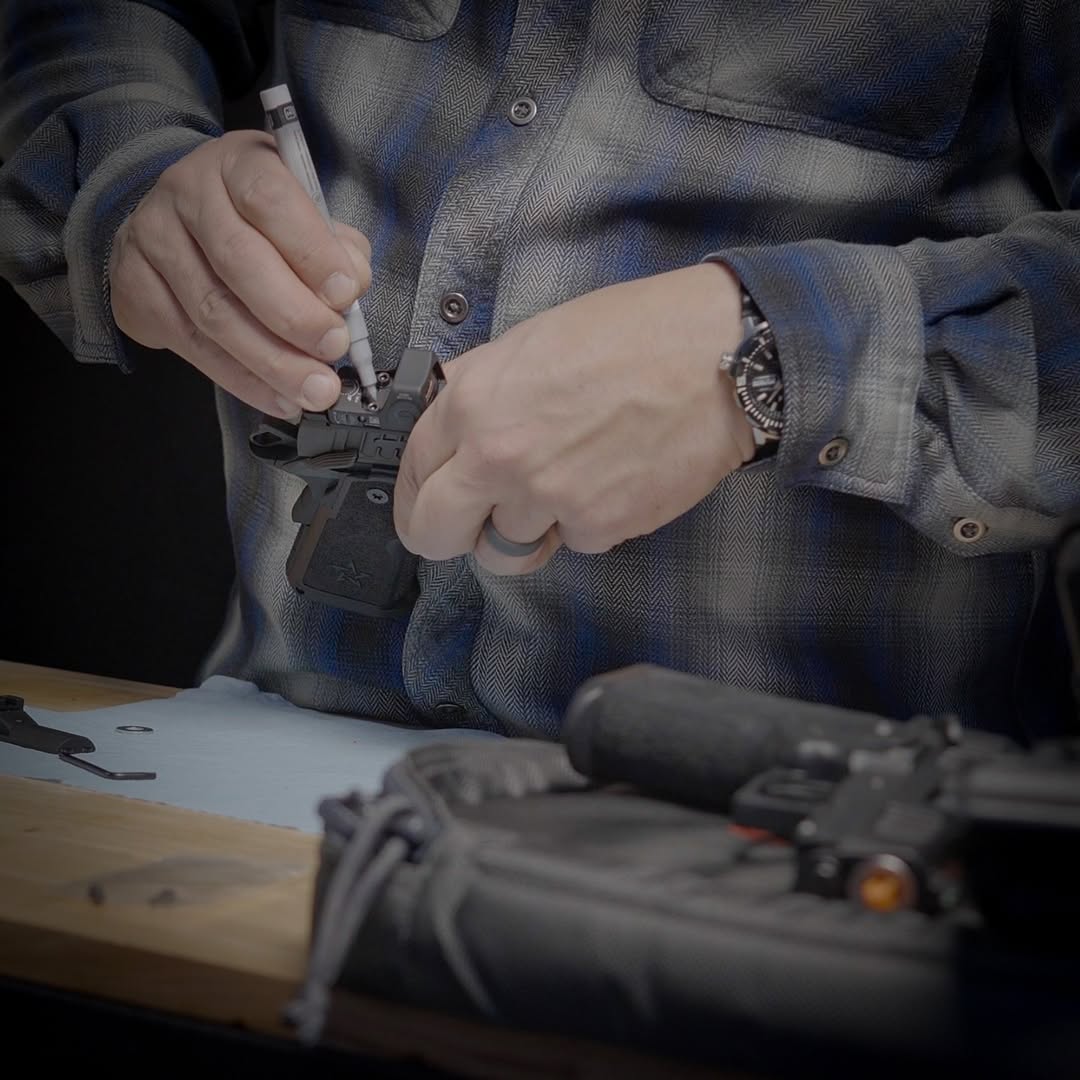 M<an demonstrating how to mount a red dot sight.
