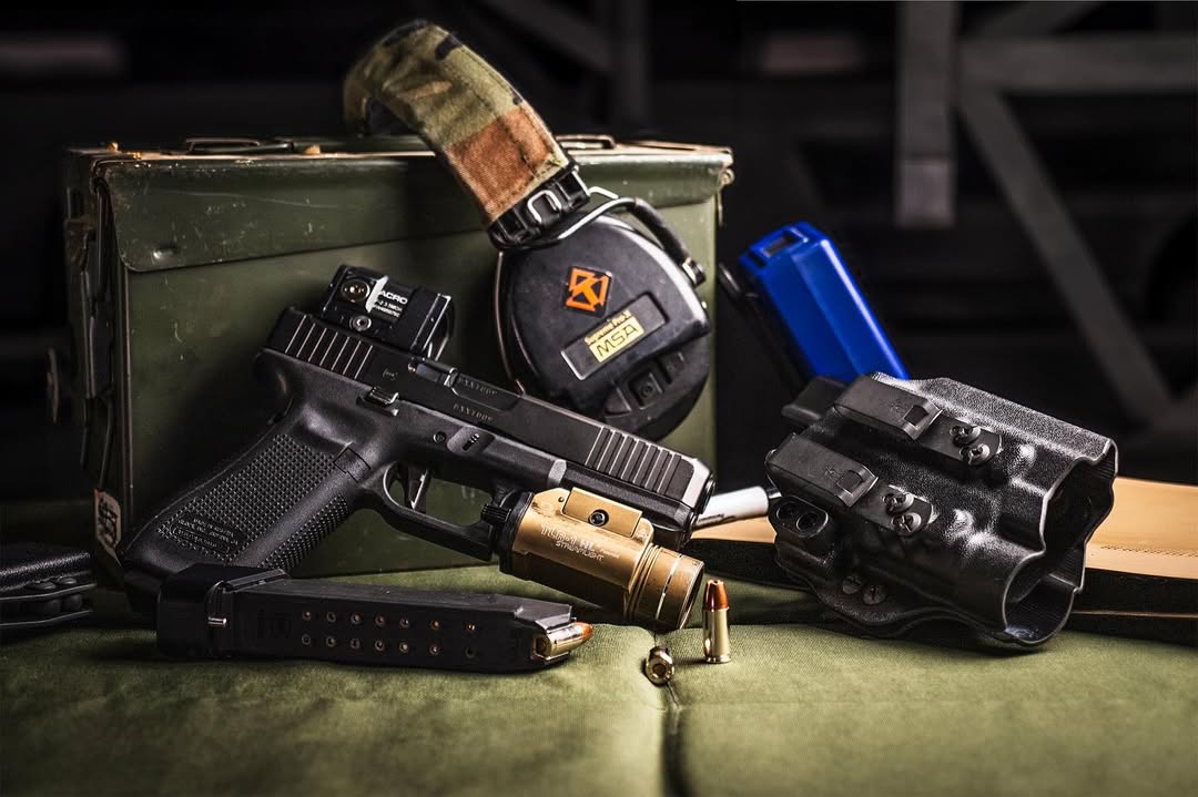 Handgun, ear protection, holster and magazine for a shooting range bag.