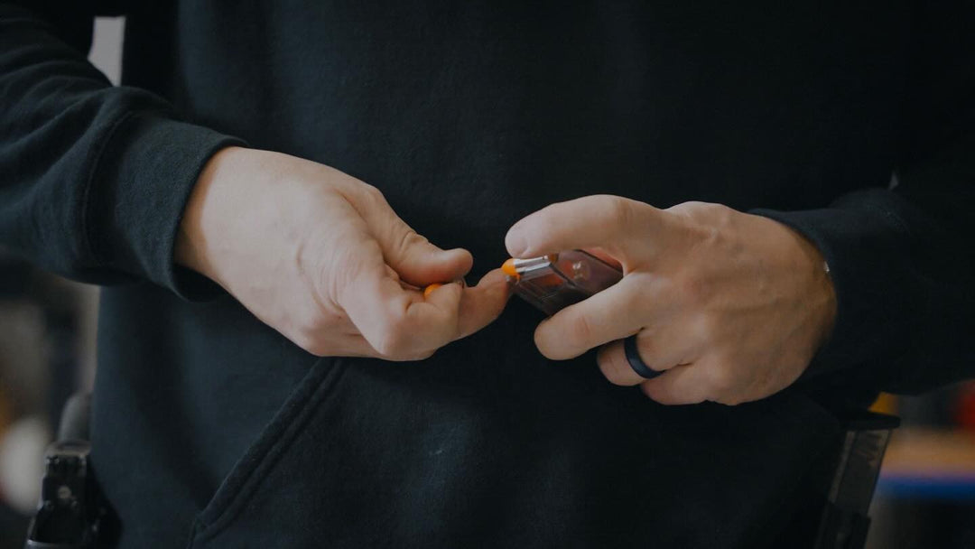 Man reloading a handgun magazine.
