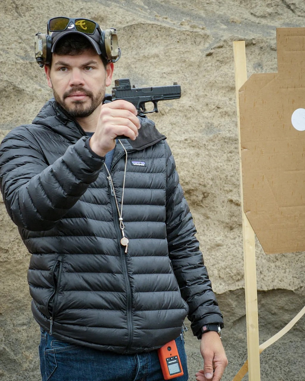 Man holding up a handgun in a safe direction during a self defence training session.
