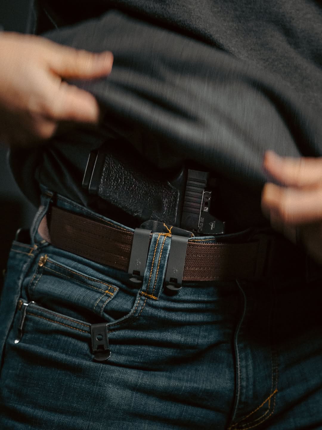 Man showing a safely holstered firearm during a self defence training session.